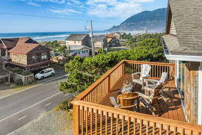 Relaxing deck with Adirondack chairs and ocean views. Beach access across the street. 