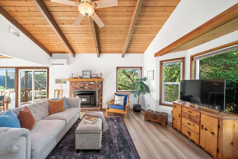 Comfy living room and streaming TV, with access to outside deck and open to the living room. Woodstove is NOT operational