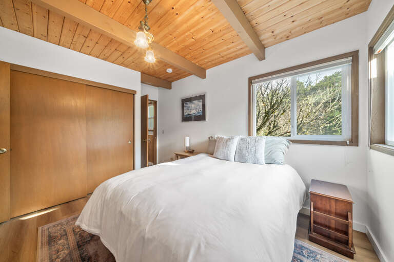 Master bedroom with Queen bed, streaming TV, and private bath with shower