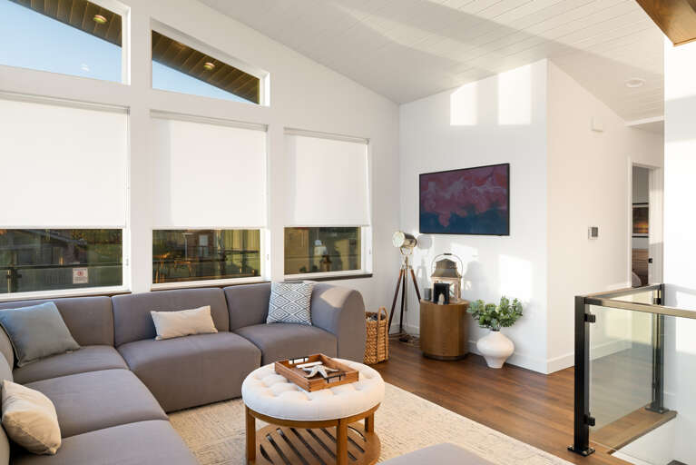 Living room with streaming TV, ocean view, and comfortable seating. 