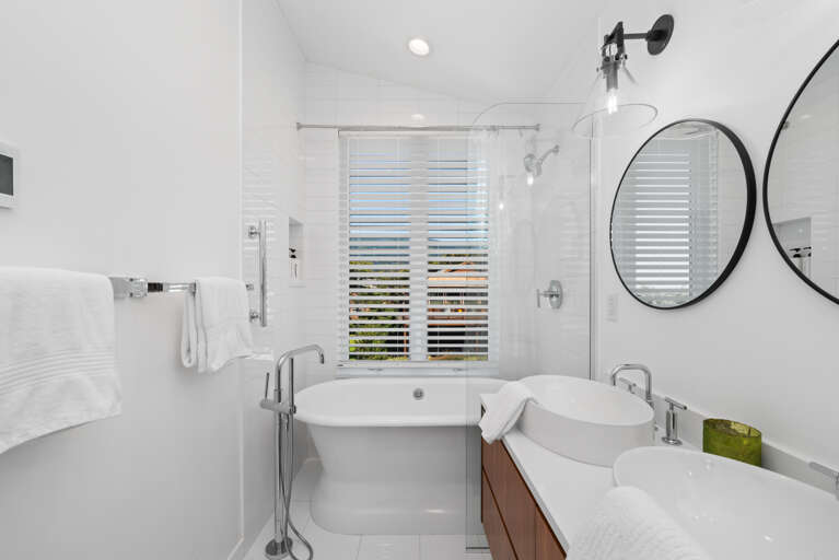 Soaker tub with ocean view and shower combination, with double sinks in the master bath.