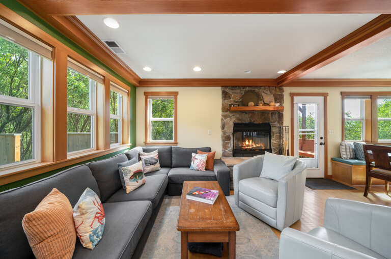 Living room with wood fireplace open to kitchen and dining area. Streaming TV and cable. 