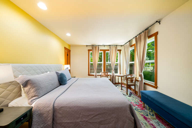 Main floor King bedroom with attached jack and jill bathroom that is also accessible from the hallway. 