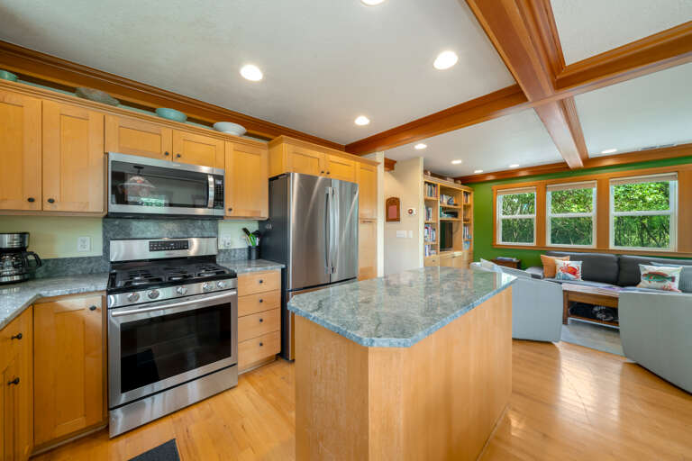 Fully equipped kitchen with gas stove and island. Open to living space and dining room. 