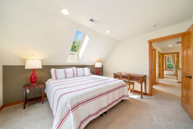 Upstairs bedroom with King and twin beds, private deck with ocean views, and desk for working. 