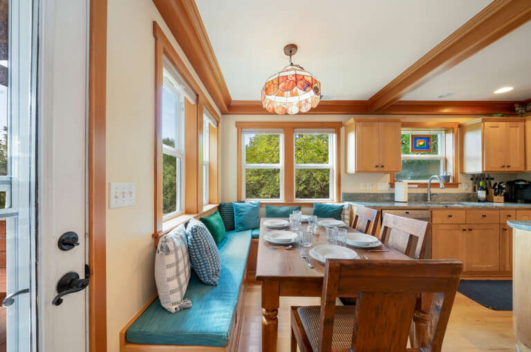 Bench seating for the dining table area that is open to the fully equipped kitchen. 
