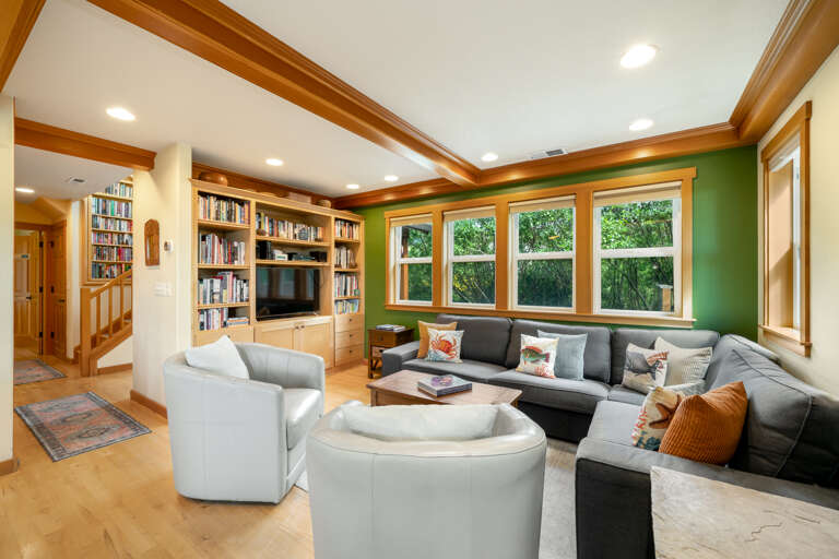 Living room open to Kitchen and dining. With Smart TV, books, DVD, VCR, 