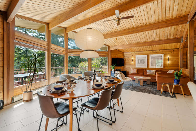 Open living room with large comfy couch, Smart TV, Dining area, and open to the Kitchen. 