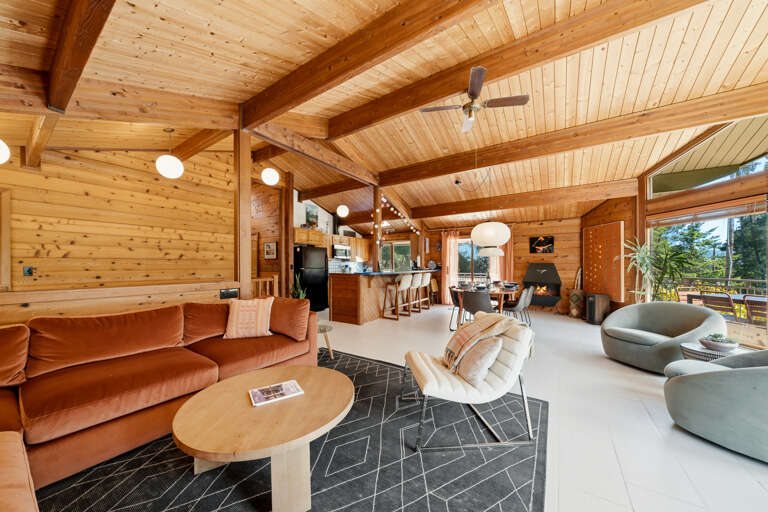 Open living room with large comfy couch, Smart TV, Dining area, and open to the Kitchen. 