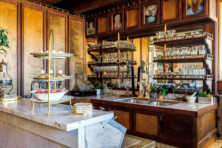 "Experience vintage charm and sweet delights at our Victorian-inspired ice cream saloon, featuring exquisite glassware and delectable treats in a nostalgic setting."
