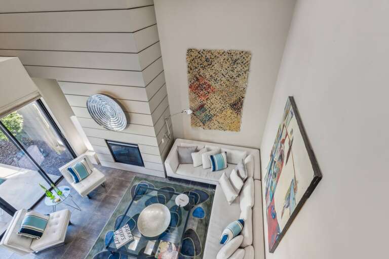 From the loft, enjoy views of the living room and the inviting pool courtyard below. From the loft, enjoy views of the living room and the inviting pool courtyard below.
