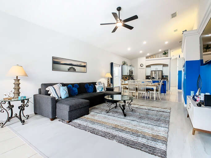 - Bright open concept living room with cozy sectional, coastal pillows, and Mickey accents
- Stylish mix of dark furnishings and crisp whites creates a clean, modern beachy feel
- Seamless flow to dining and kitchen areas makes it ideal for entertaining
- Bright open concept living room with cozy sectional, coastal pillows, and Mickey accents
- Stylish mix of dark furnishings and crisp whites creates a clean, modern beachy feel
- Seamless flow to dining and kitchen areas makes it ideal for entertaining