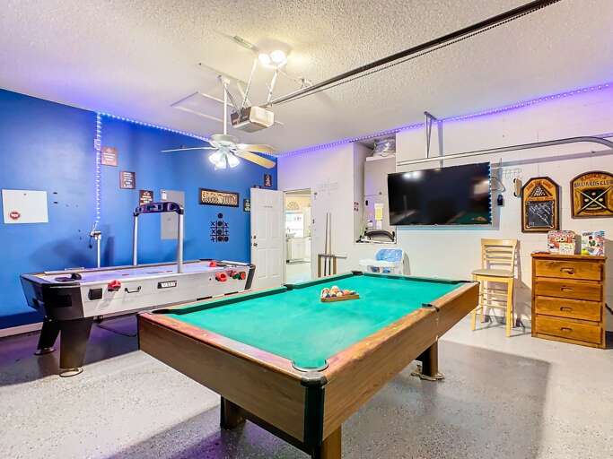 Blue Room With Billiard Table, Big Screen TV, And Bar Stools