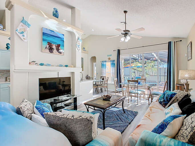 - Breezy coastal living room with plush seating, seaside décor, and cheerful charm
- Large glass doors lead to the patio, filling the space with natural Florida sunshine
- Relax, stream your favorite shows, or dine together in this open concept oasis - Breezy coastal living room with plush seating, seaside décor, and cheerful charm
- Large glass doors lead to the patio, filling the space with natural Florida sunshine
- Relax, stream your favorite shows, or dine together in this open concept oasis