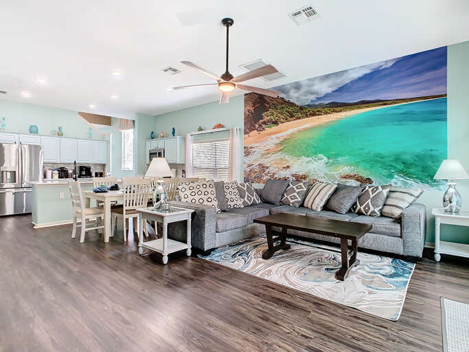 - Spacious open layout with a large beach mural that adds a serene coastal vibe
- Plush gray sectional and patterned pillows offer comfy seating for the whole group
- Full kitchen, dining set, and ocean toned decor perfect for gathering and relaxing - Spacious open layout with a large beach mural that adds a serene coastal vibe
- Plush gray sectional and patterned pillows offer comfy seating for the whole group
- Full kitchen, dining set, and ocean toned decor perfect for gathering and relaxing