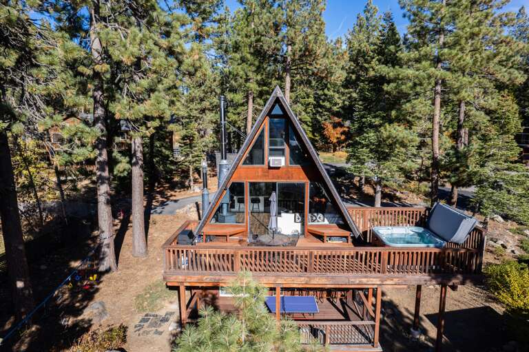 Soak up the sun from the back deck! Enjoy the private hot tub, patio table and BBQ grill. Plus there is a ping pong table underneath the deck.