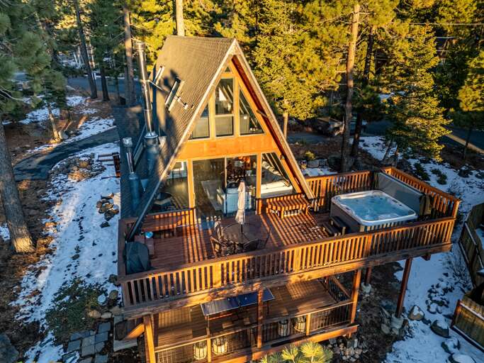 Soak up the sun from the back deck! Enjoy the private hot tub, patio table and BBQ grill. Plus there is a ping pong table underneath the deck.