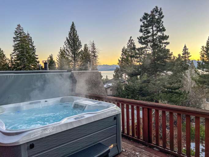 Soak up the sun from the back deck! Enjoy the private hot tub, patio table and BBQ grill. Plus there is a ping pong table underneath the deck.