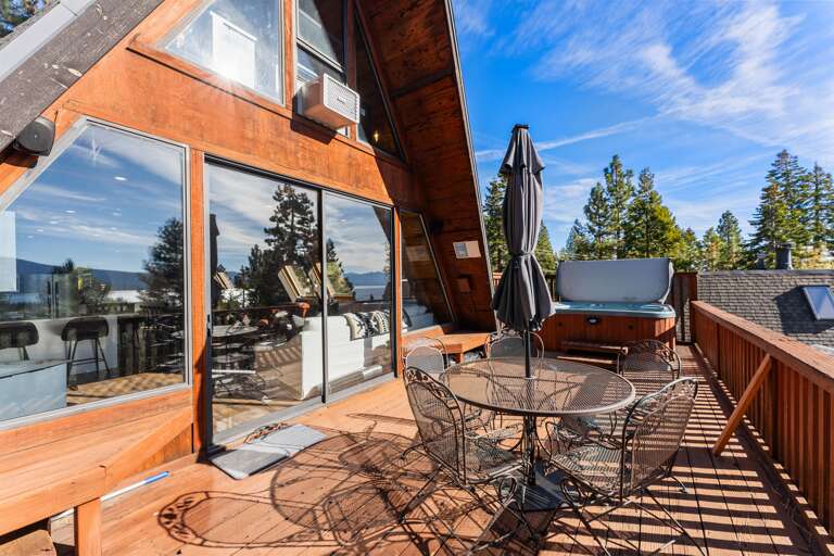 Soak up the sun from the back deck! Enjoy the private hot tub, patio table and BBQ grill. Plus there is a ping pong table underneath the deck.
