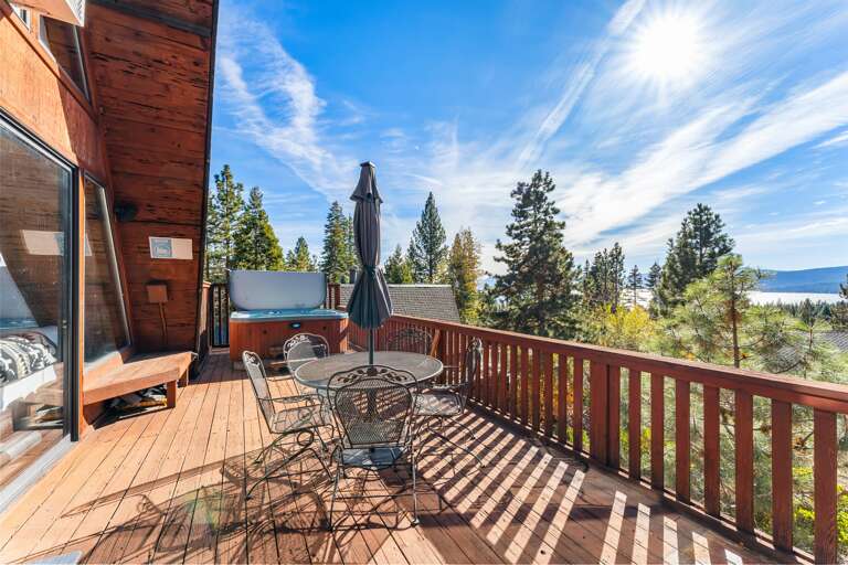 Soak up the sun from the back deck! Enjoy the private hot tub, patio table and BBQ grill. Plus there is a ping pong table underneath the deck.