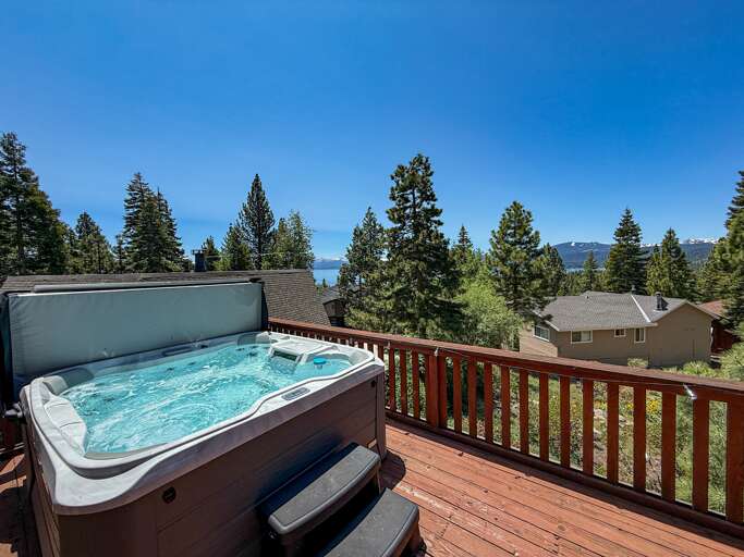 Soak up the sun from the back deck! Enjoy the private hot tub, patio table and BBQ grill. Plus there is a ping pong table underneath the deck.
