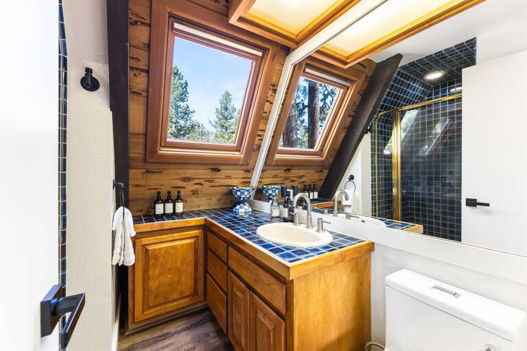 Full bathroom - Located on the second floor. This bathroom features a single vanity and walk-in shower. Thoughtfully stocked with shampoo, conditioner, body wash, hand soap and toilet paper for a comfortable stay.