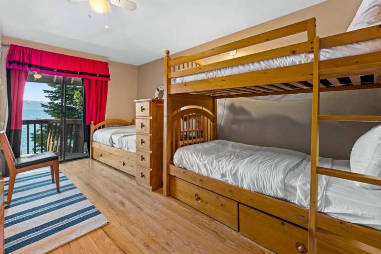 Upstairs Bunk Room - Features 3 twin beds and a trundle bed, stunning views of Lake Tahoe, and a private balcony to take in the scenery.