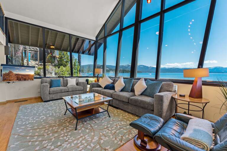 Enjoy panoramic Lake Tahoe views from the living room with floor-to-ceiling windows. Listen to the waves crash on the rocks below as you relax by the gas fireplace or watch your favorite shows on the smart TV.