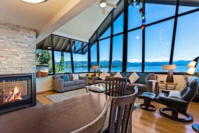 Enjoy panoramic Lake Tahoe views from the living room with floor-to-ceiling windows. Listen to the waves crash on the rocks below as you relax by the gas fireplace or watch your favorite shows on the smart TV.