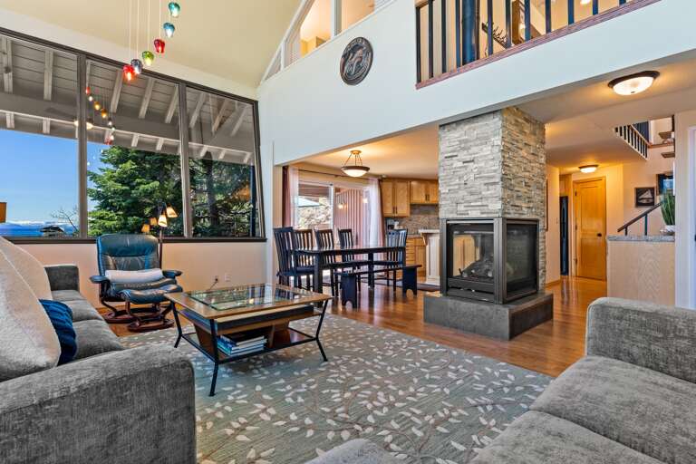 Enjoy panoramic Lake Tahoe views from the living room with floor-to-ceiling windows. Listen to the waves crash on the rocks below as you relax by the gas fireplace or watch your favorite shows on the smart TV.