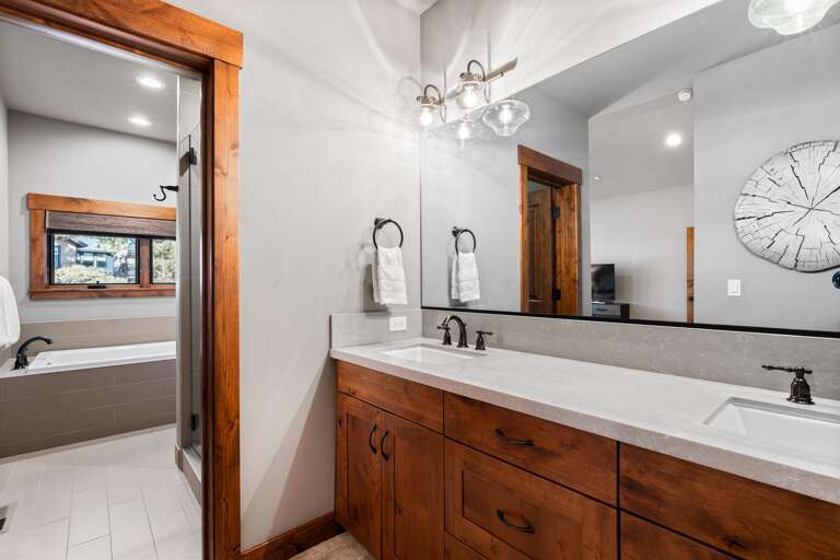 This bathroom features dual vanities, a soaking tub, and a spacious walk-in shower, offering both style and functionality. Thoughtfully stocked with shampoo, conditioner, and body wash for a comfortable and convenient stay. This bathroom features dual vanities, a soaking tub, and a spacious walk-in shower, offering both style and functionality. Thoughtfully stocked with shampoo, conditioner, and body wash for a comfortable and convenient stay.