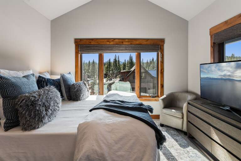 This upstairs luxurious master suite boasts a plush king bed, 49" Smart TV and an en-suite bathroom, making it a serene retreat after a day of Tahoe adventures. This upstairs luxurious master suite boasts a plush king bed, 49" Smart TV and an en-suite bathroom, making it a serene retreat after a day of Tahoe adventures.