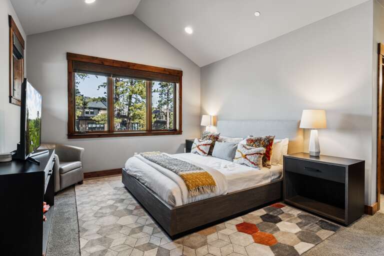 This luxurious upstairs master suite features a plush king bed, a 49" Smart TV, and an en-suite bathroom, offering a serene retreat perfect for unwinding after a day of Tahoe adventures. This luxurious upstairs master suite features a plush king bed, a 49" Smart TV, and an en-suite bathroom, offering a serene retreat perfect for unwinding after a day of Tahoe adventures.