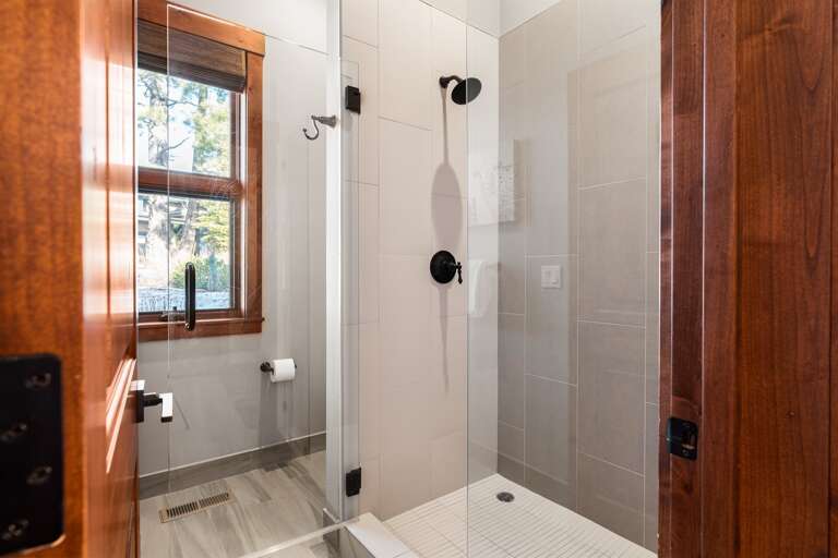 The spa-like primary bathroom features dual vanities and a walk-in shower, creating a serene space for relaxation. Essentials such as toilet paper, hand soap, shampoo, conditioner, and body wash are provided for your convenience. The spa-like primary bathroom features dual vanities and a walk-in shower, creating a serene space for relaxation. Essentials such as toilet paper, hand soap, shampoo, conditioner, and body wash are provided for your convenience.