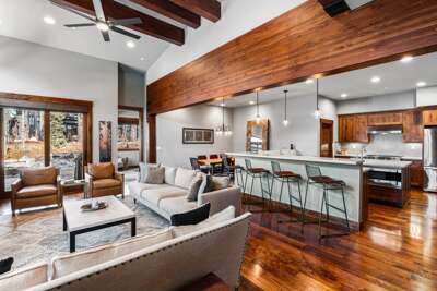 Relax in the inviting great room, where soaring ceilings and large windows flood the space with natural light. Cozy up by the stone fireplace and enjoy the 55" Smart TV.