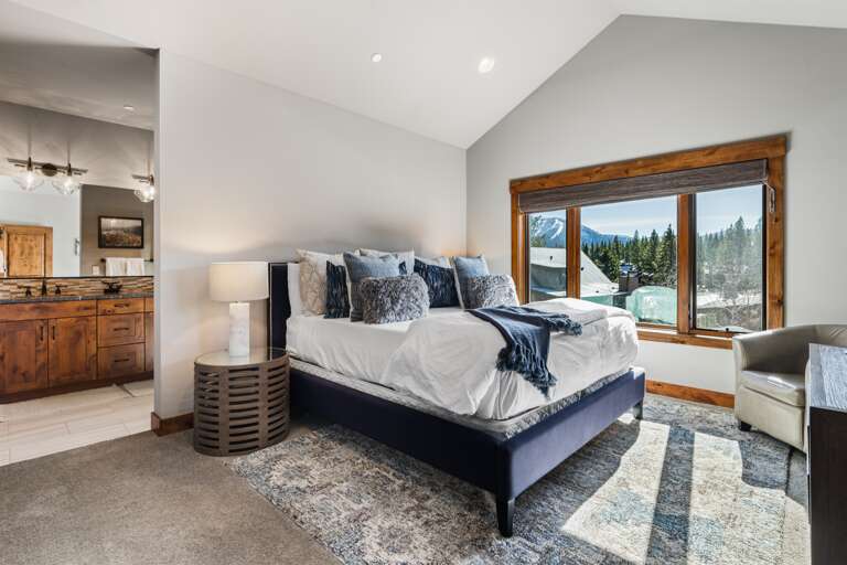 This upstairs luxurious master suite boasts a plush king bed, 49" Smart TV and an en-suite bathroom, making it a serene retreat after a day of Tahoe adventures.