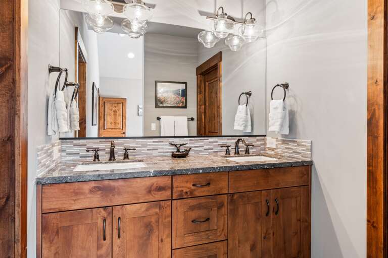This bathroom features dual vanities and a spacious walk-in shower, providing both style and functionality. Thoughtfully stocked with shampoo, conditioner, and body wash for a comfortable stay. This bathroom features dual vanities and a spacious walk-in shower, providing both style and functionality. Thoughtfully stocked with shampoo, conditioner, and body wash for a comfortable stay.