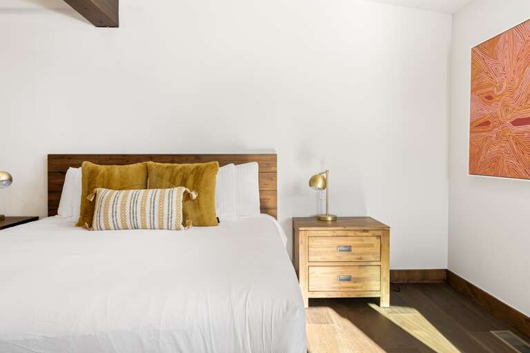 The luxurious master suite boasts a plush king bed and an en-suite bathroom, making it a serene retreat after a day of Tahoe adventures.