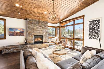 Relax in the inviting great room, where soaring ceilings and large windows flood the space with natural light while framing the picturesque mountain scenery. Cozy up by the stone fireplace and enjoy the 50" Smart TV.
