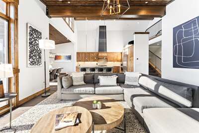 Relax in the inviting great room, where soaring ceilings and large windows flood the space with natural light while framing the picturesque mountain scenery. Cozy up by the stone fireplace and enjoy the 50" Smart TV.