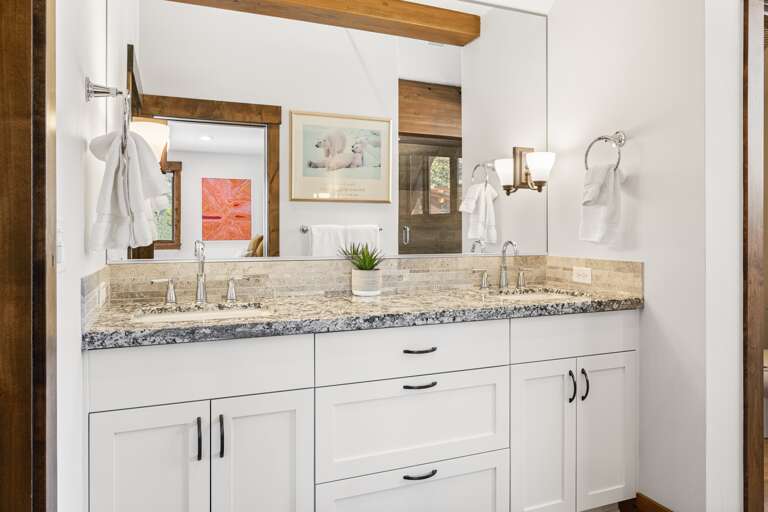 The spa-like master bathroom features a soaking tub, dual vanities, and a walk-in shower, creating the perfect space for relaxation.