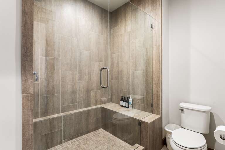 This bathroom features dual vanities and a spacious walk-in shower, providing both style and functionality. Thoughtfully stocked with shampoo, conditioner, and body wash for a comfortable stay. This bathroom features dual vanities and a spacious walk-in shower, providing both style and functionality. Thoughtfully stocked with shampoo, conditioner, and body wash for a comfortable stay.