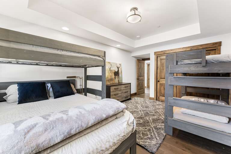 The bunk room is perfect for families or groups, featuring a twin-over-twin and a twin-over-queen bunk bed to comfortably accommodate guests of all ages. With its own en-suite bathroom, this space offers convenience and privacy. The bunk room is perfect for families or groups, featuring a twin-over-twin and a twin-over-queen bunk bed to comfortably accommodate guests of all ages. With its own en-suite bathroom, this space offers convenience and privacy.