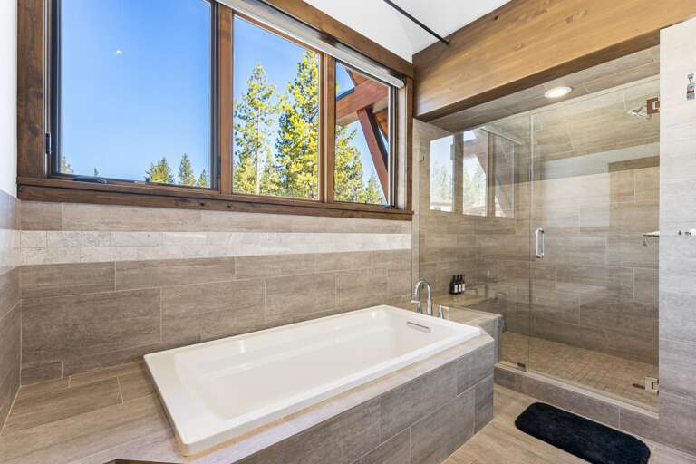 The spa-like master bathroom features a soaking tub, dual vanities, and a walk-in shower, creating the perfect space for relaxation.