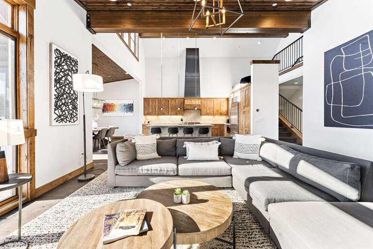 Relax in the inviting great room, where soaring ceilings and large windows flood the space with natural light while framing the picturesque mountain scenery. Cozy up by the stone fireplace and enjoy the 50