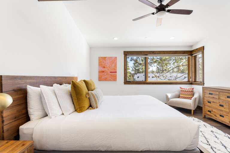 The luxurious master suite boasts a plush king bed and an en-suite bathroom, making it a serene retreat after a day of Tahoe adventures.