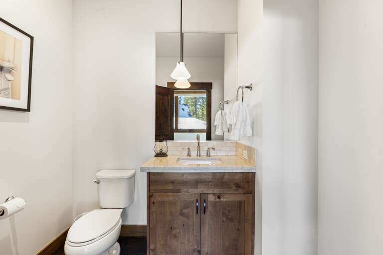 This half bathroom features a single vanity and is thoughtfully stocked with ample hand soap and toilet paper for a comfortable stay. This half bathroom features a single vanity and is thoughtfully stocked with ample hand soap and toilet paper for a comfortable stay.