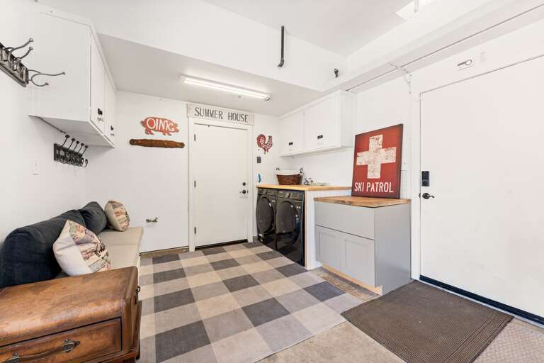 The garage has been transformed into a fun-filled game room featuring shuffleboard, air hockey, and foosball — and it's fully heated for year-round enjoyment. In the summer, open up the garage door for fresh air and indoor-outdoor vibes!