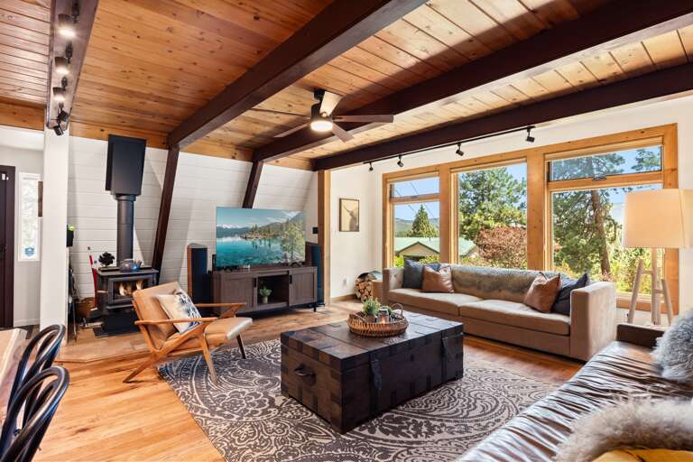 Cozy up in the heart of the home, floor-to-ceiling windows, 65" Smart TV and a wood-burning fireplace set the mood for your mountain escape. Whether it’s morning coffee or après-ski wine, this is the place to be.