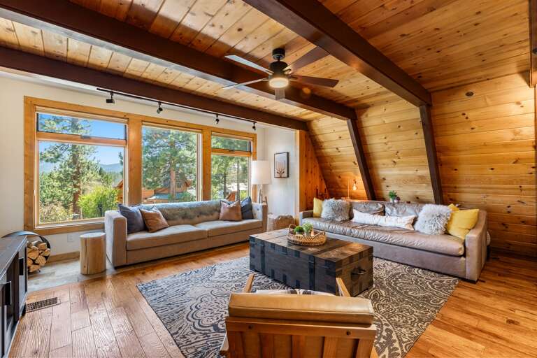 Cozy up in the heart of the home, floor-to-ceiling windows, 65" Smart TV and a wood-burning fireplace set the mood for your mountain escape. Whether it’s morning coffee or après-ski wine, this is the place to be.